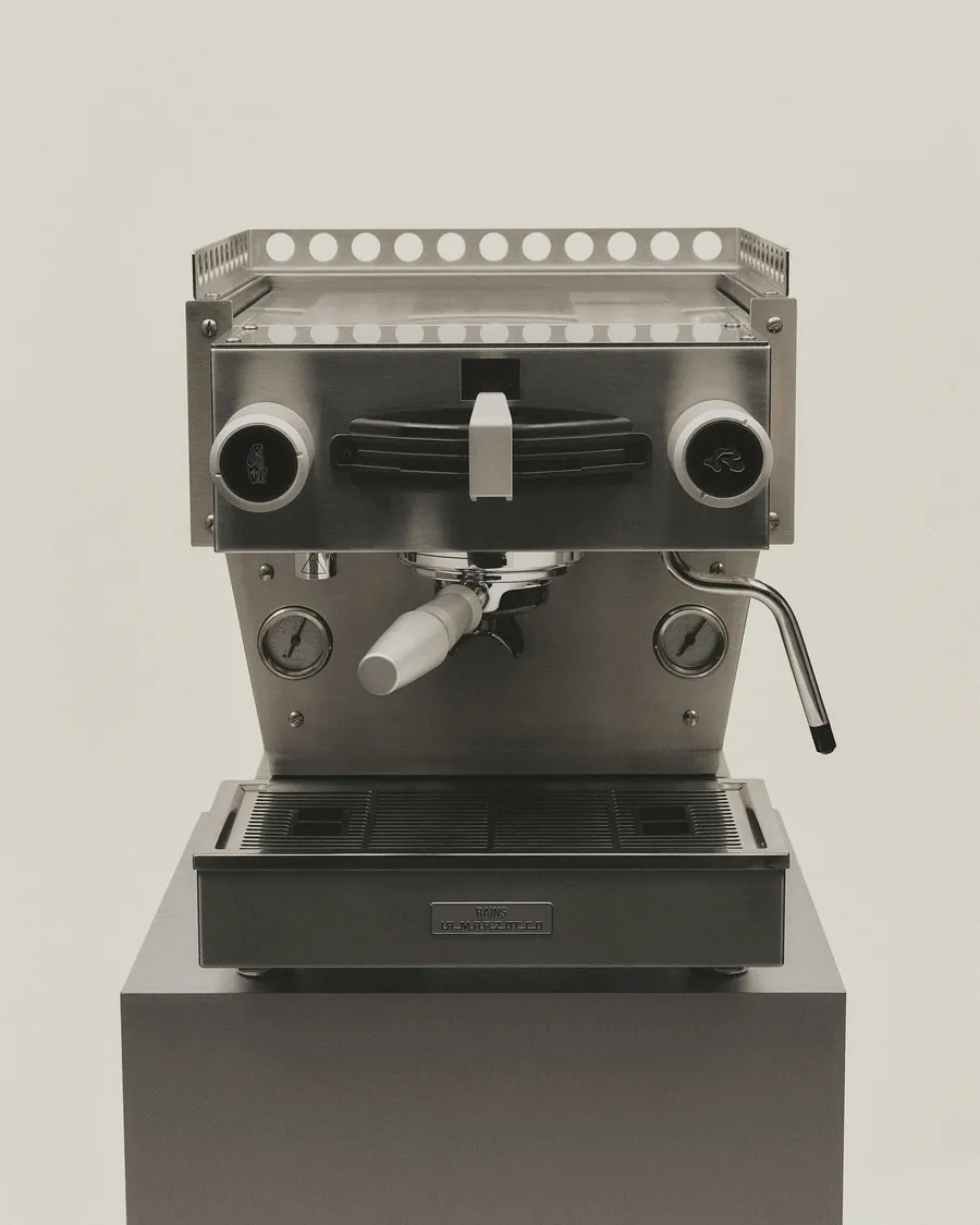 Linea Mini by Officine Fratelli Bambi from the La Marzocco and Rains collaboration, with a Rains plate, on a plinth